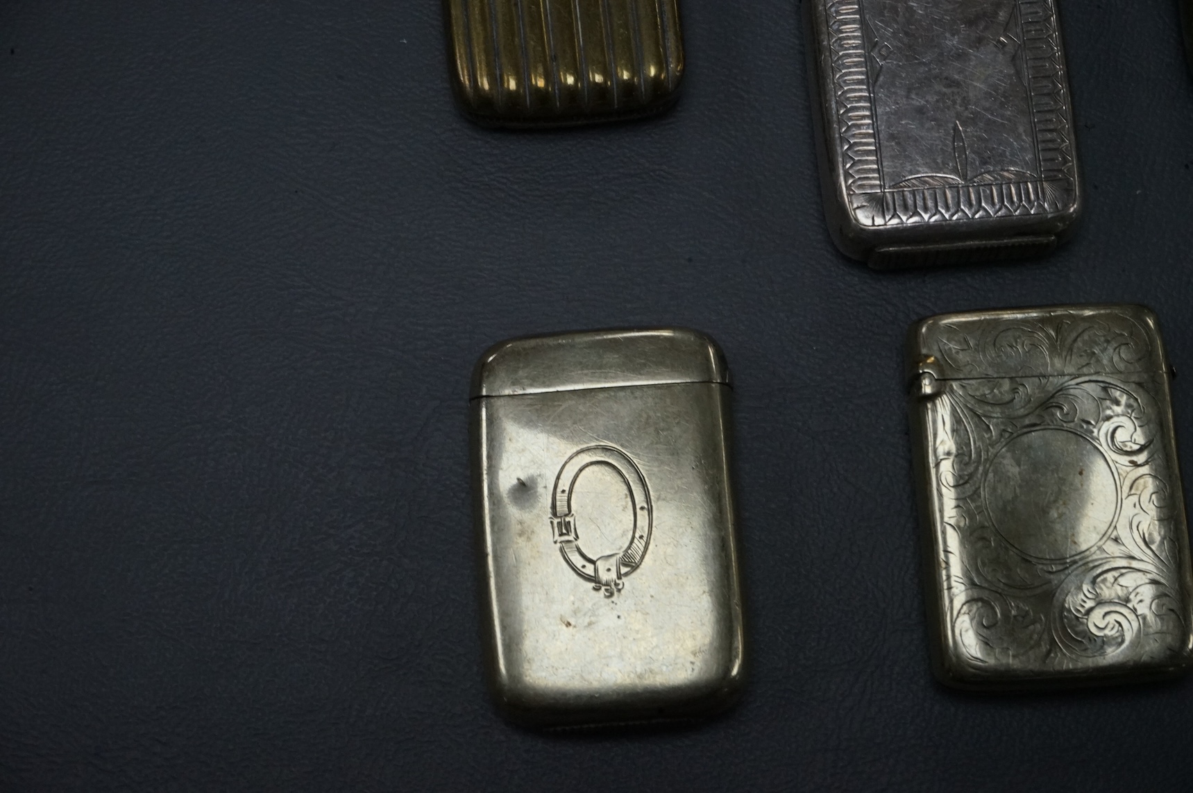 Seven base metal vesta cases, largest 6cm high